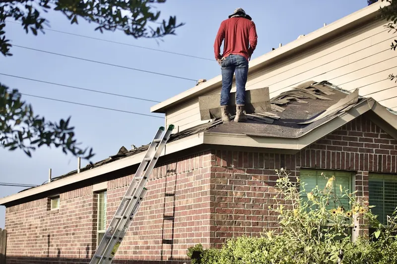 Professional roofer working on a residential roof in Southern Pines